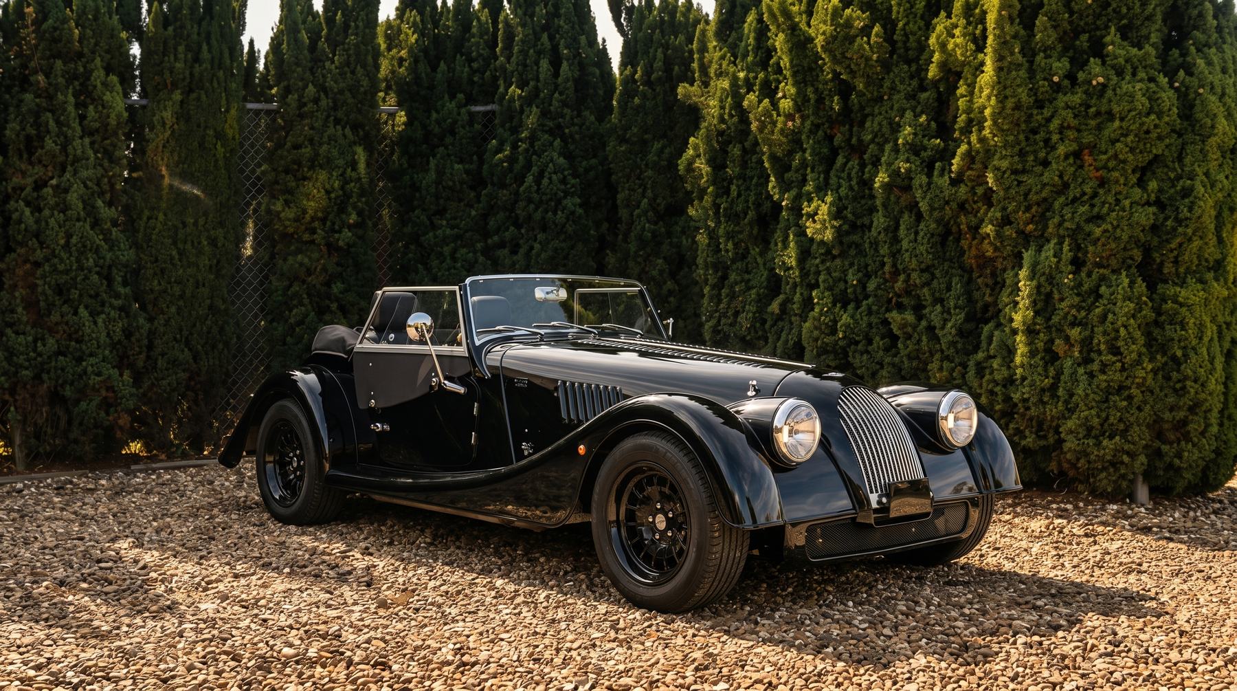 Momentum Markers September 2026, Audrey the black custom Morgan Plus Four parked on gravel in the sun