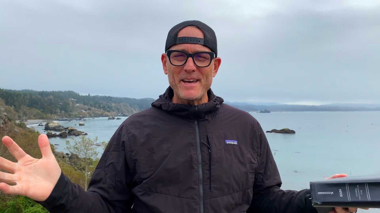 Noah standing outside with the ocean behind him